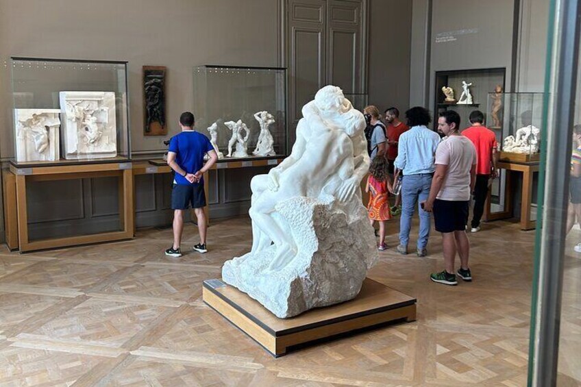 A museum interior with marble sculptures on display. 2