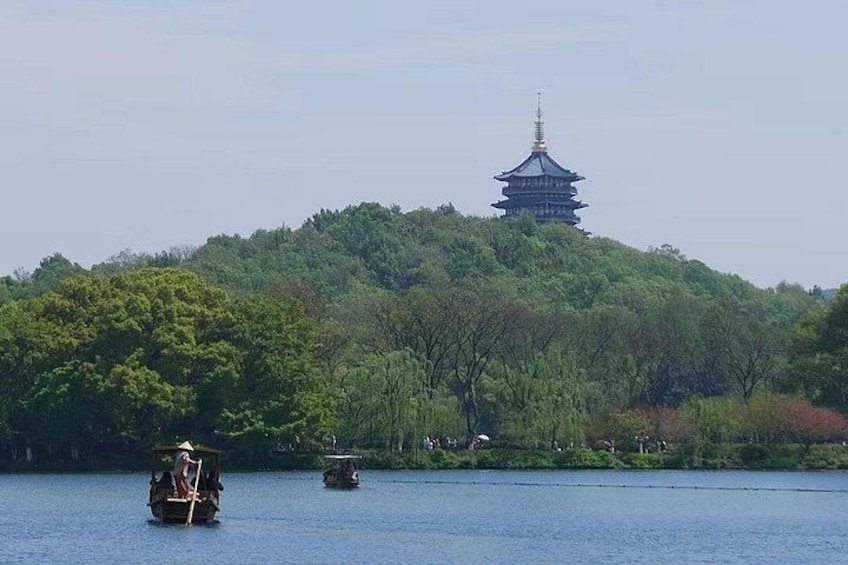 A traditional pagoda on a hill, a boat on the water, and a forested area. 3