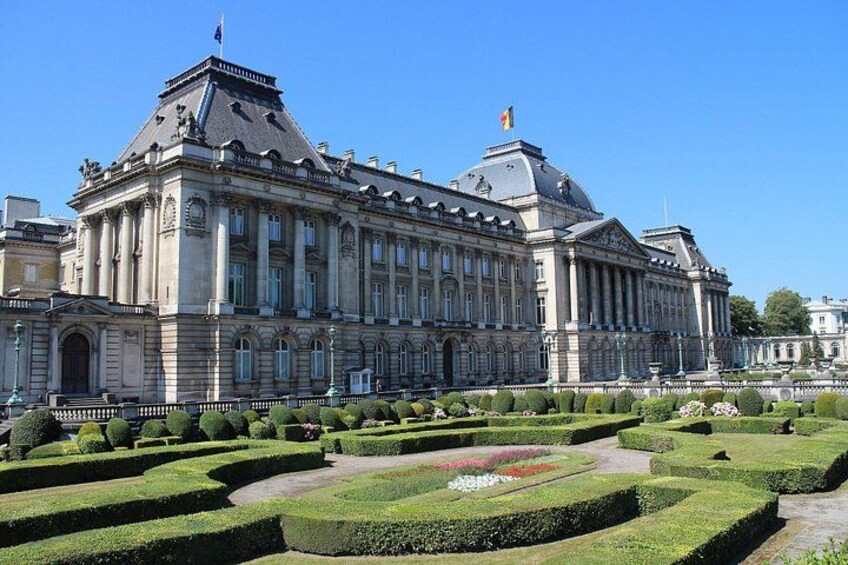 A large, historic building with a symmetrical facade, a dome, and a flagpole. 5