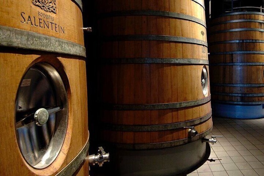 Wooden barrels with metal taps, likely used for aging wine or spirits. 5