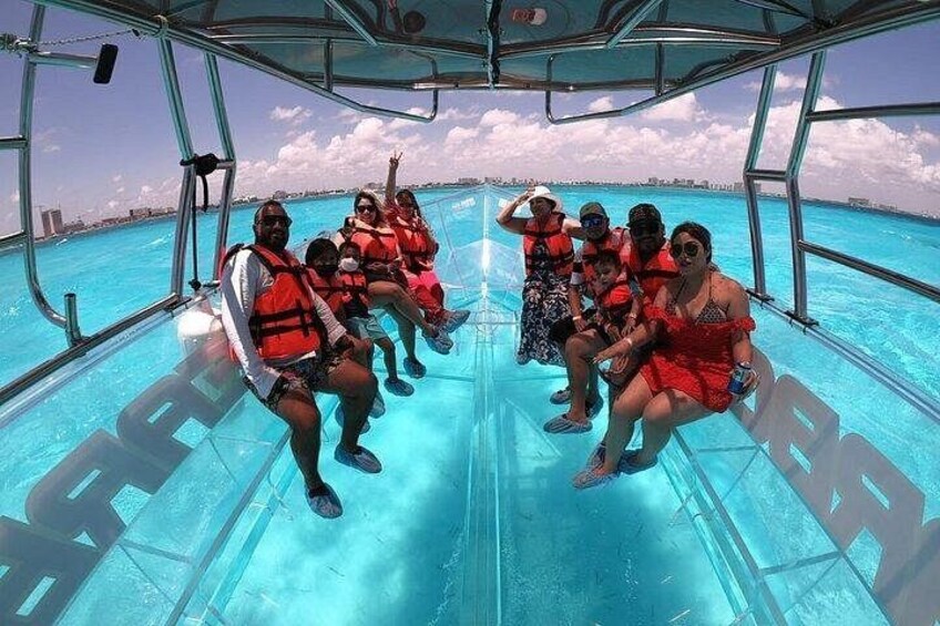 A group of people on a boat with clear blue water around them. 3