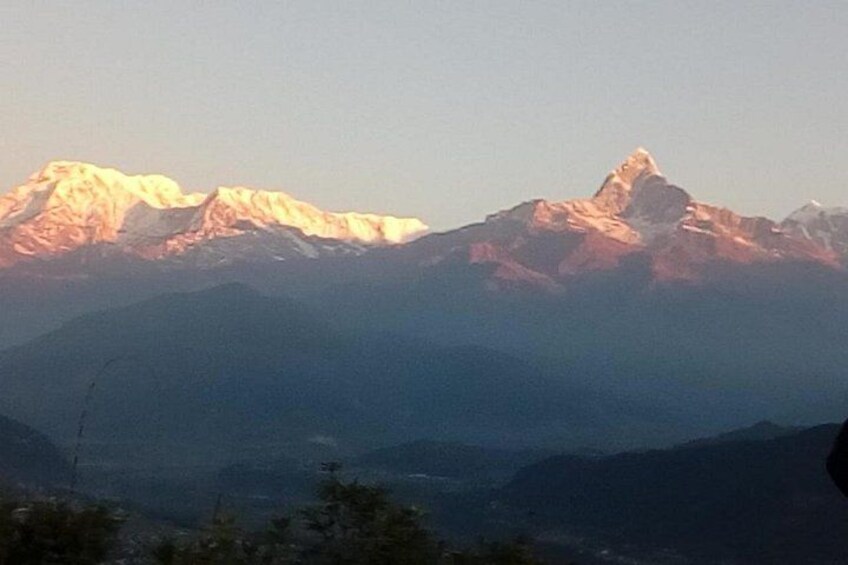 A mountain range with snow-capped peaks and a valley below. 2
