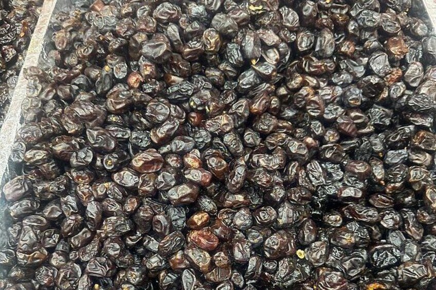 A large quantity of dried fruits, likely raisins, in a bulk container. 3