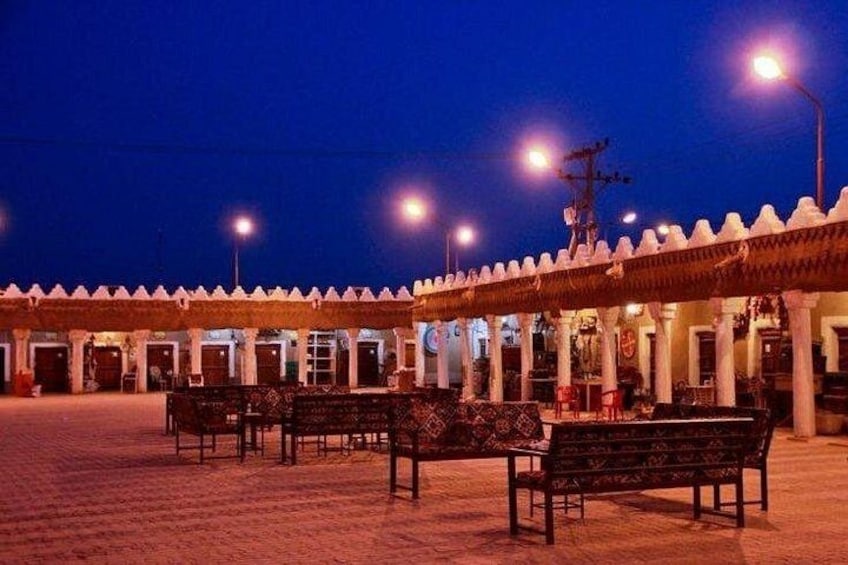A building with a traditional architectural style, featuring a series of arches and columns. 3