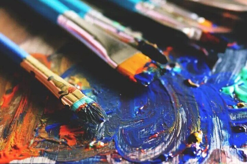 Paintbrushes and paint on a canvas. 2