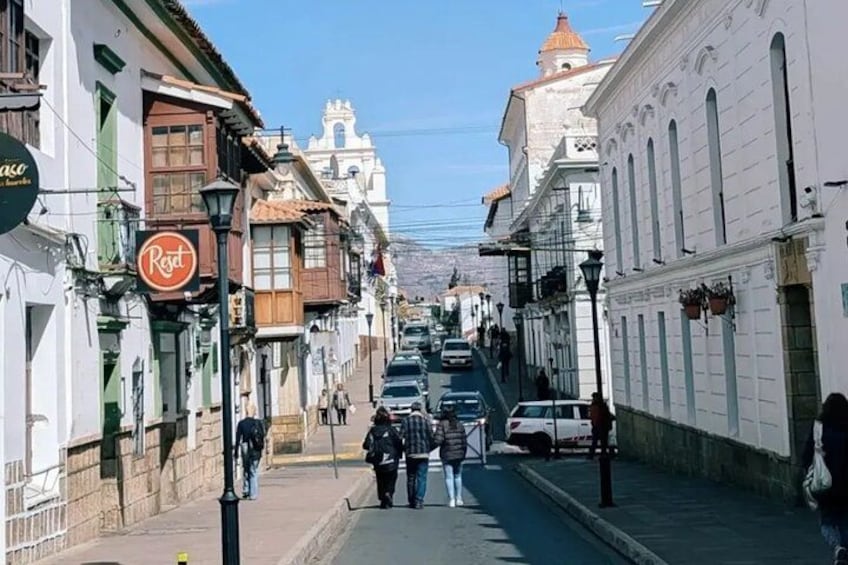 A street with buildings, a sign for 'Regal', and a clear sky. 2