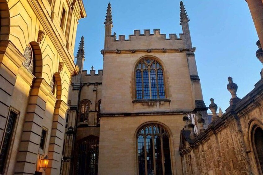 A historic building with a large arched window and a tower with battlements. 4