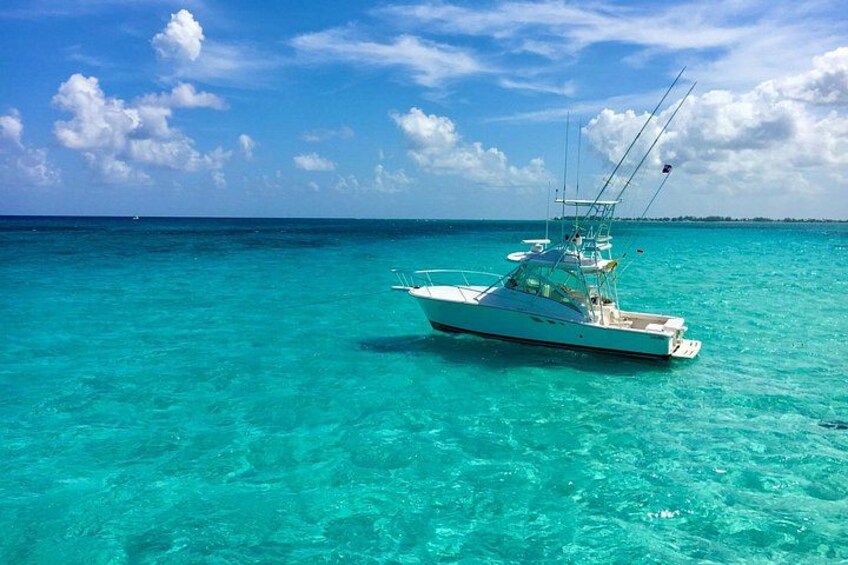 Een witte boot op turquoise water, onder een heldere lucht. 1