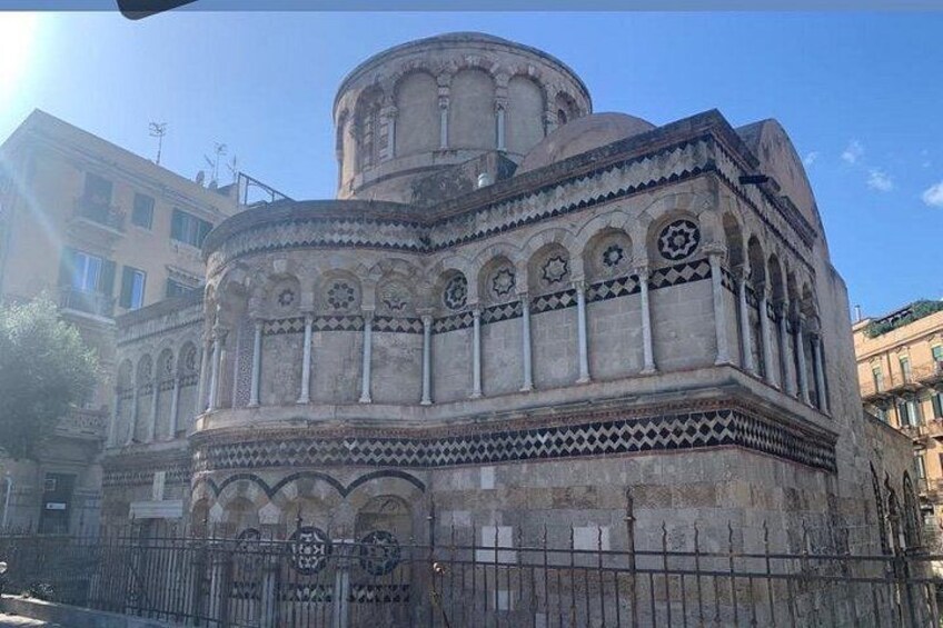 A historic building with intricate architectural details, including arches and decorative patterns. 4