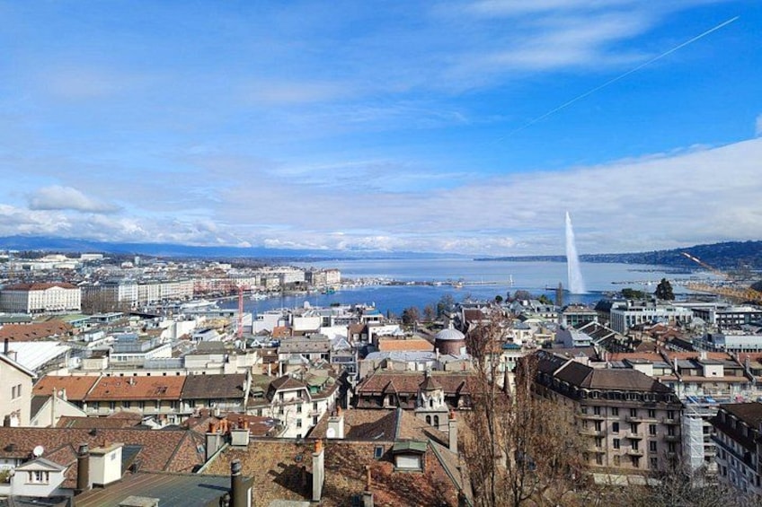A coastal cityscape with a prominent white tower, a bridge, and a body of water. 2