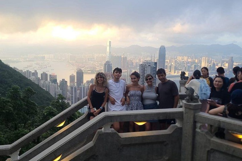 A group of people on a staircase with a cityscape in the background. 1