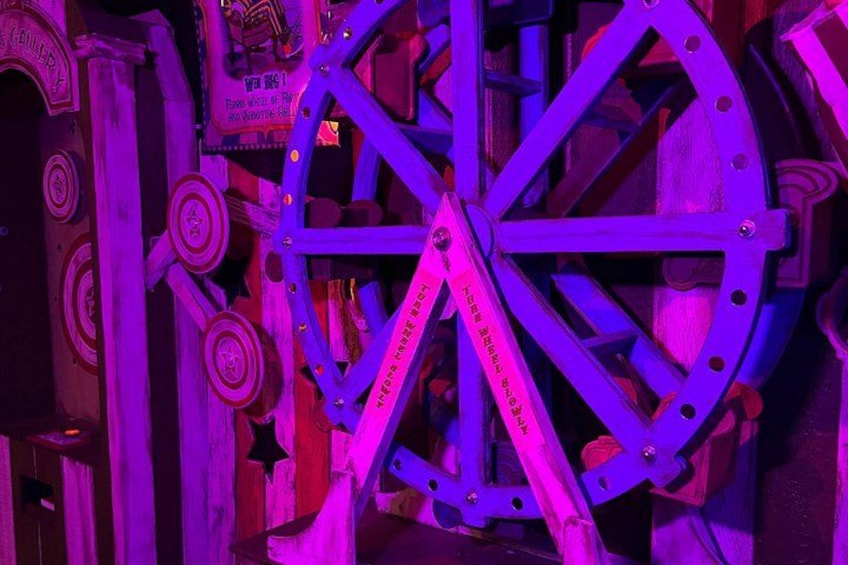 A large, ornate wheel structure with intricate designs and text. 4
