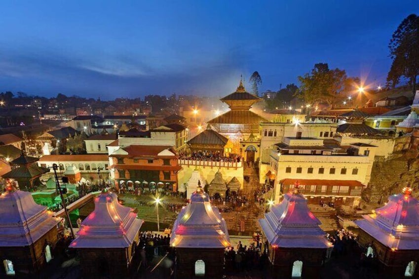 A historic town square with illuminated buildings and a prominent pagoda. 5