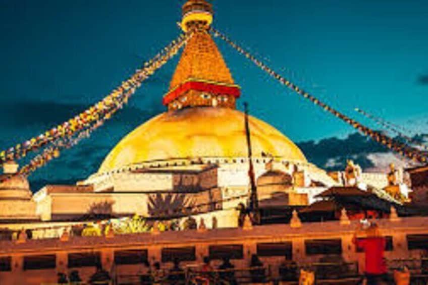 A large golden dome with a red base, surrounded by a fence and smaller buildings. 3