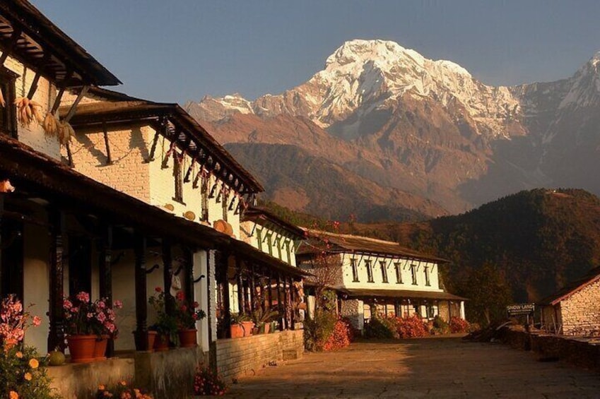 A traditional building with a mountain backdrop. 1