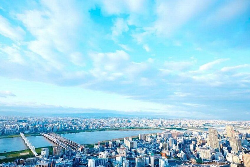 A cityscape with a river, bridges, and a clear sky. 3
