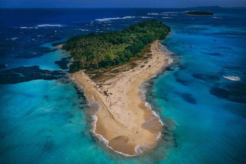 An aerial view of a tropical island with a sandy beach and clear turquoise waters. 3