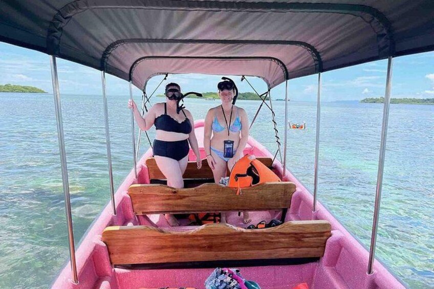 Two people in a boat with a canopy, on a body of water. 2