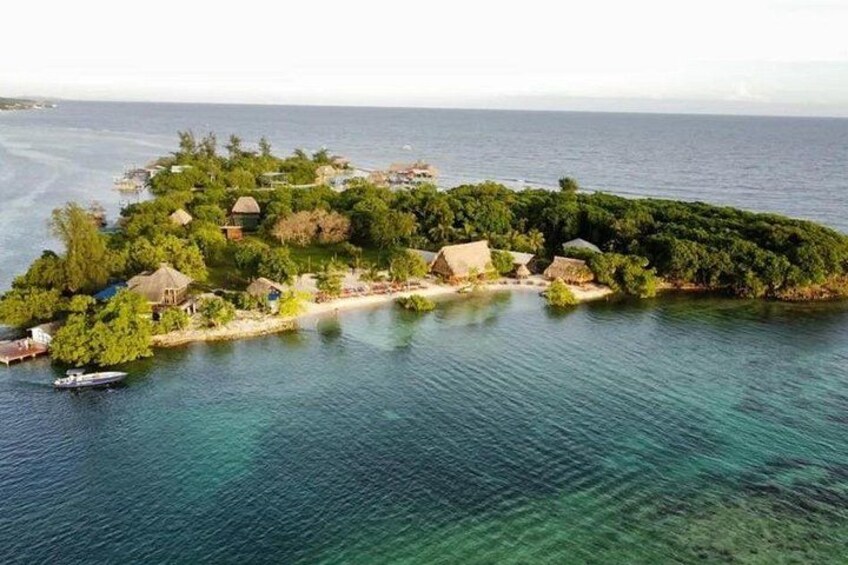 A tropical island with clear blue waters, lush greenery, and traditional huts. 2