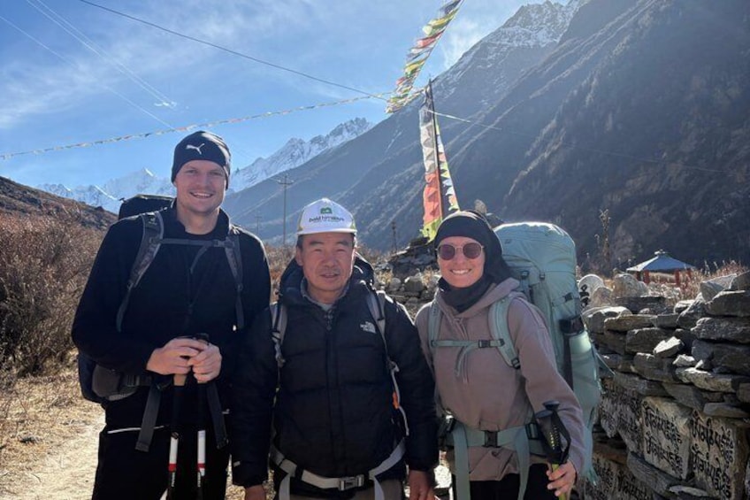 Three hikers with backpacks on a mountain trail. 3