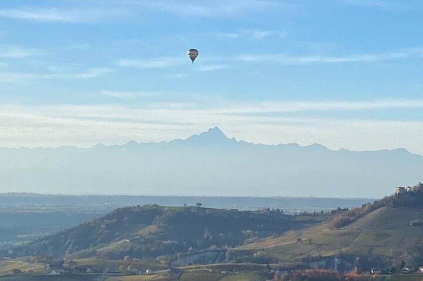 A hot air balloon over a mountainous landscape with a clear sky. 2
