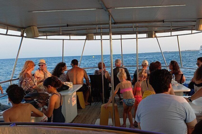 A group of people on a boat with a view of the open sea. 5