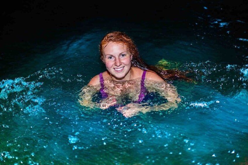 A person swimming in clear blue water. 2