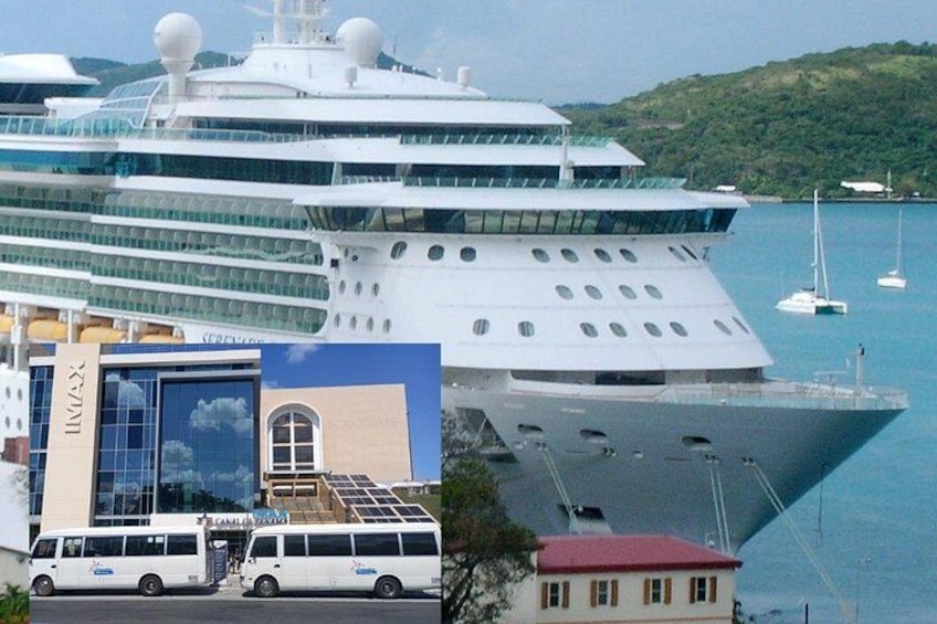 A large cruise ship docked at a port with a building and a small house in the foreground. 1
