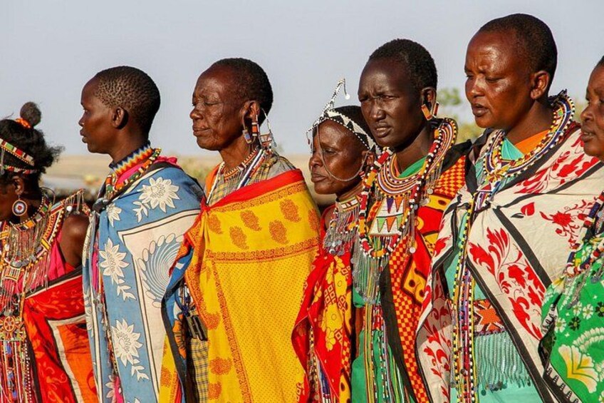 A group of people in traditional attire with colorful patterns and jewelry. 4