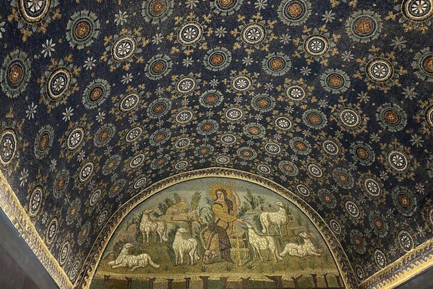A ceiling with intricate geometric patterns and a central fresco depicting a pastoral scene. 5