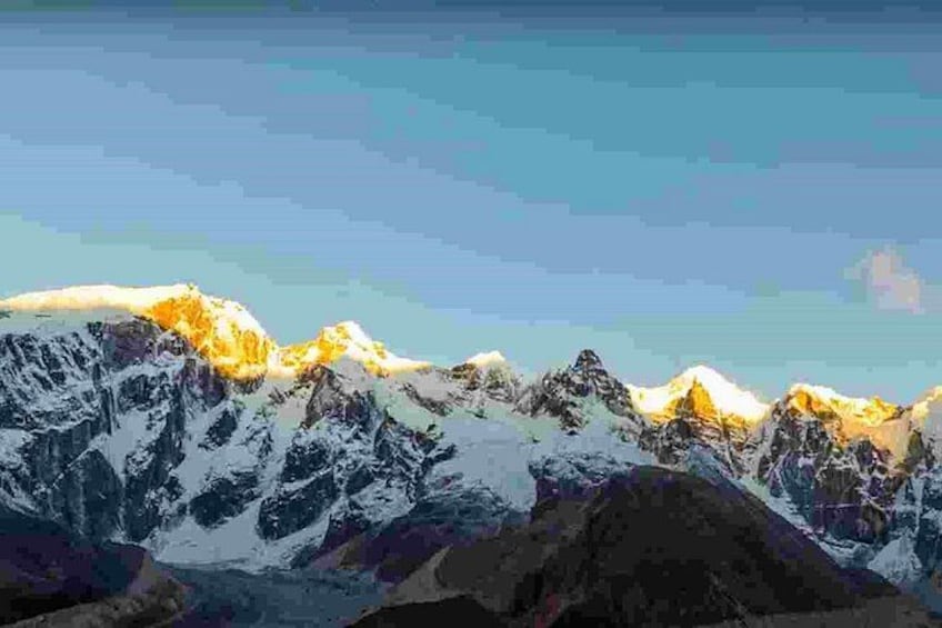 A mountain range with snow-covered peaks and a clear sky. 4