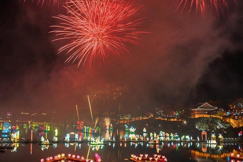A nighttime cityscape with fireworks, illuminated buildings, and a traditional pagoda. 3