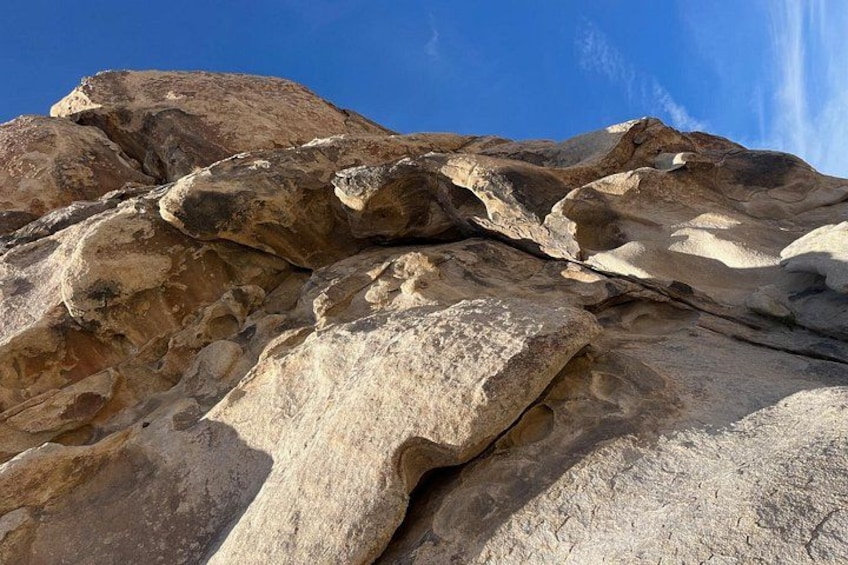 A large rock formation with layered sedimentary structures. 3