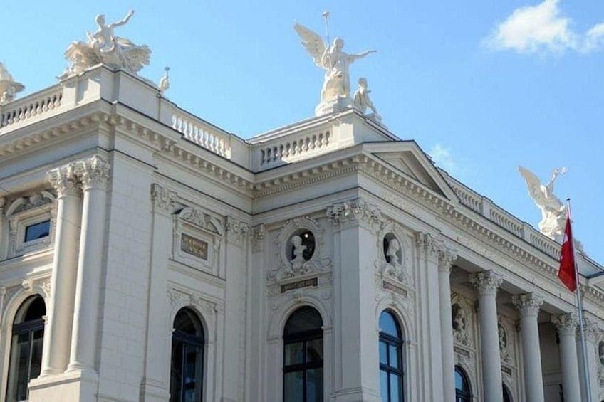 A classical building with ornate columns and statues. 3