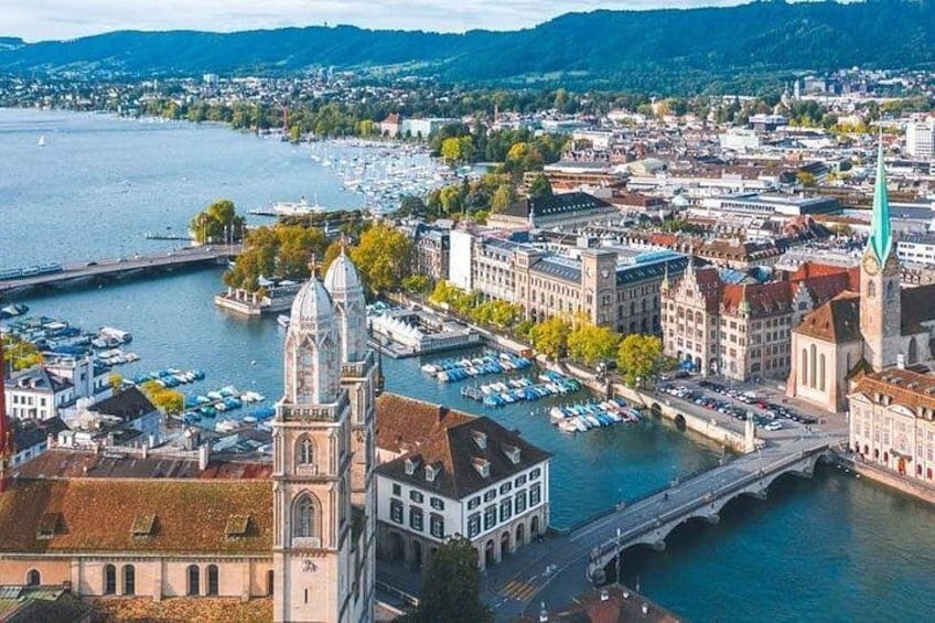 A riverside cityscape with historic buildings, a prominent church, and a bridge. 4