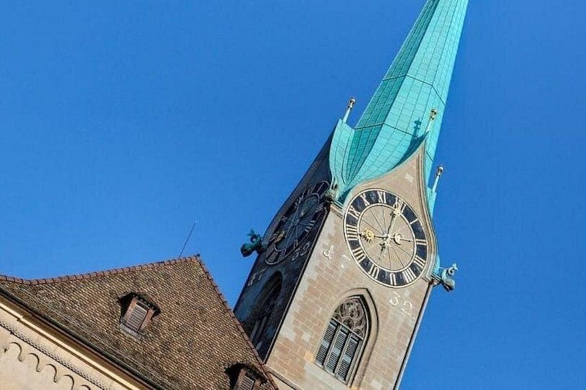 A church tower with a clock and a spire. 2