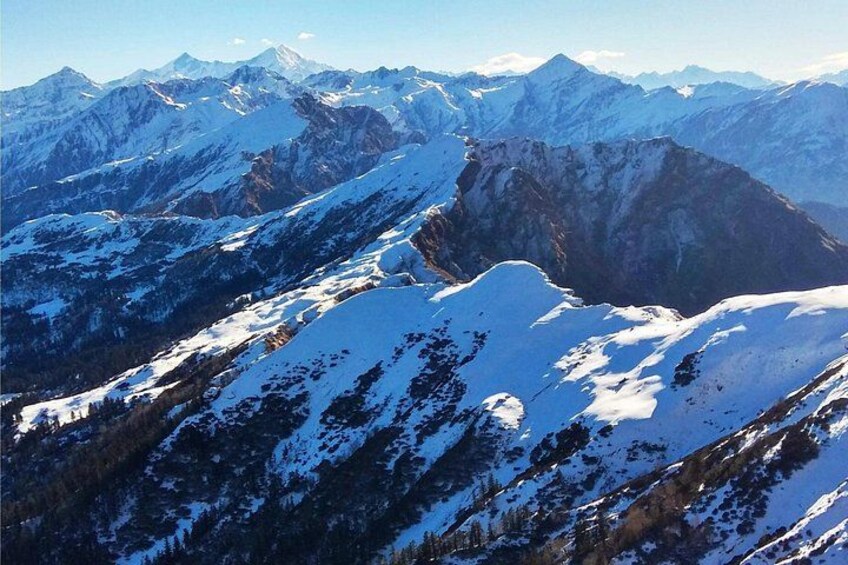 A snow-covered mountain range with rugged peaks and valleys. 5