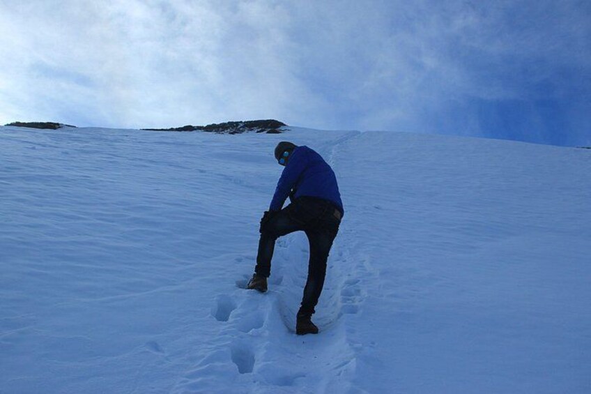 A person snowboarding on a snowy slope. 3