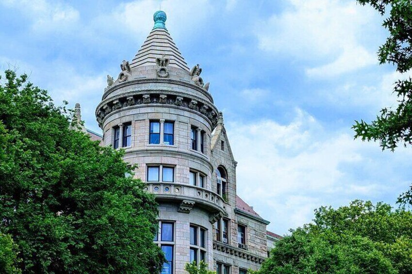 A historic building with a distinctive tower and arched windows. 2