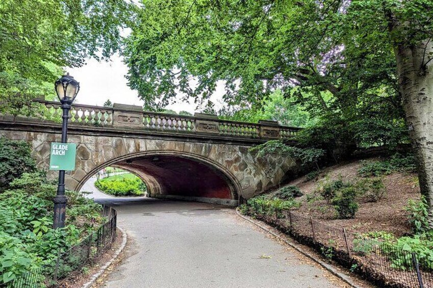 A stone bridge with a sign reading "Glade Arch" and a lamp post. 3