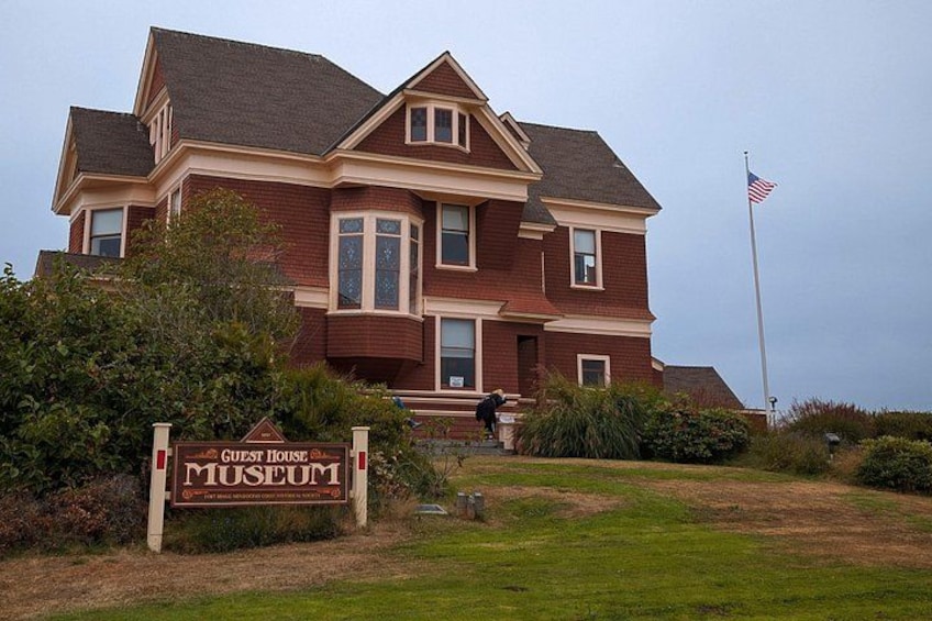 A large two-story building with a sign reading 'Guest House Museum.' 3