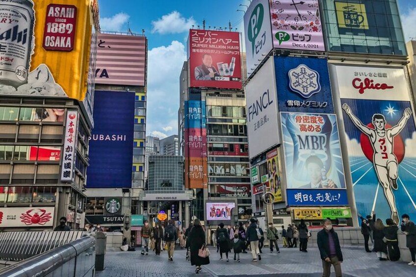 A busy urban street with various commercial billboards and signs in a foreign language. 3