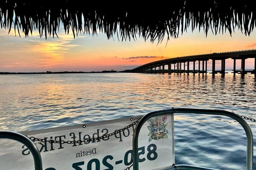 A sunset over a body of water with a pier extending into the water. 3