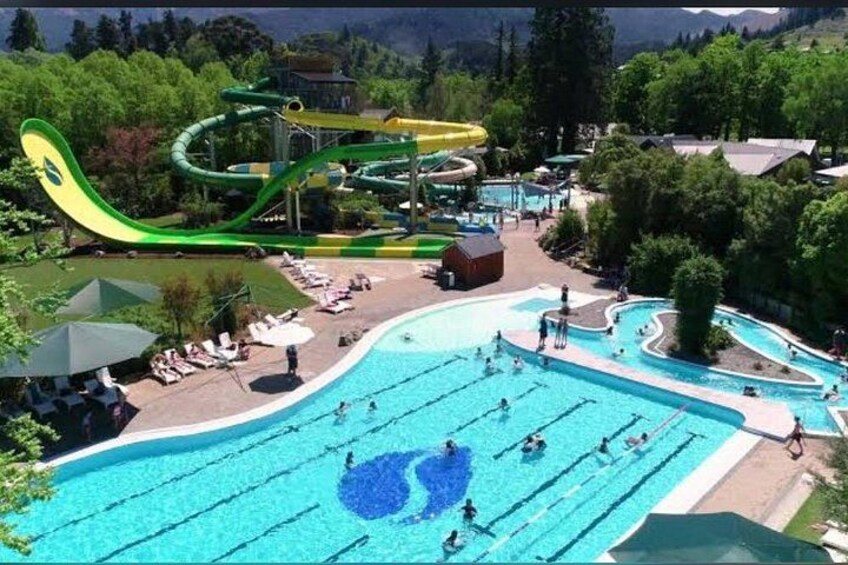A water park with multiple pools and a large slide. 3
