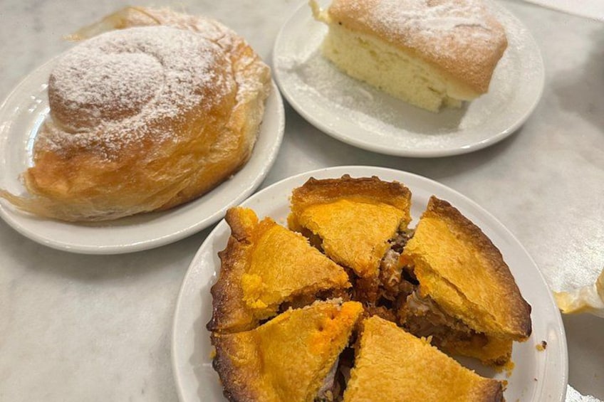 Three plates of pastries: a puff pastry, a slice of cake, and a pie with fruit filling. 4