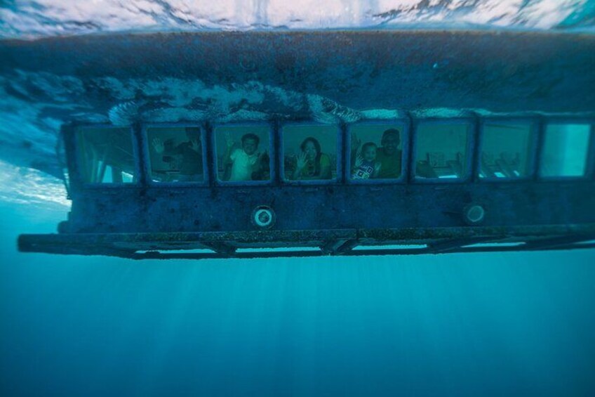 An underwater scene with a submerged structure, possibly a shipwreck, with people inside. 1