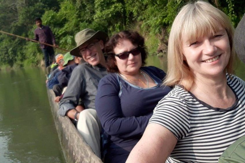 People on a narrow waterway, surrounded by greenery. 3