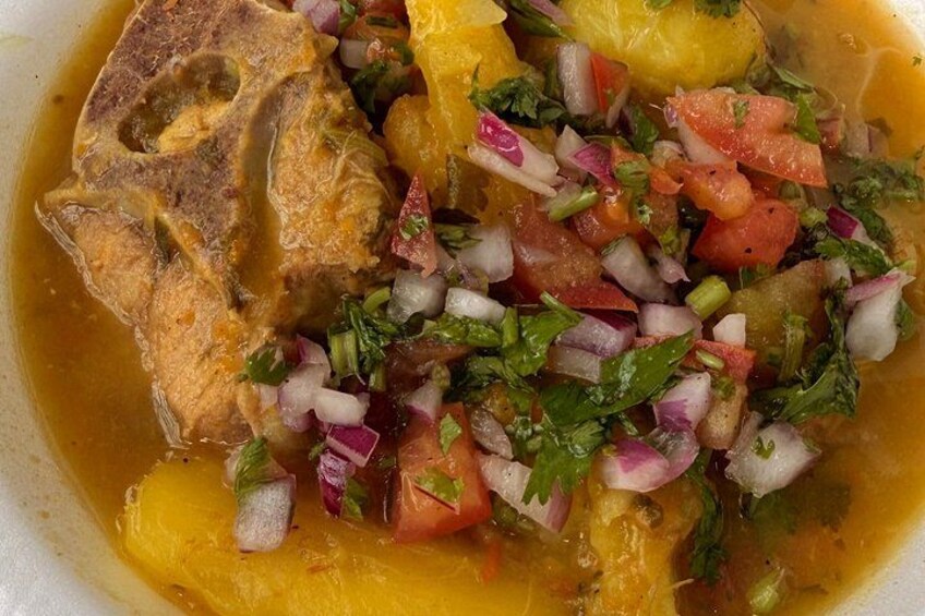 A dish with fish, diced tomatoes, onions, and herbs. 3
