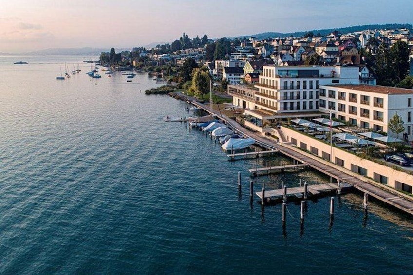 A coastal town with a marina, waterfront buildings, and a bridge connecting the land to the water. 4