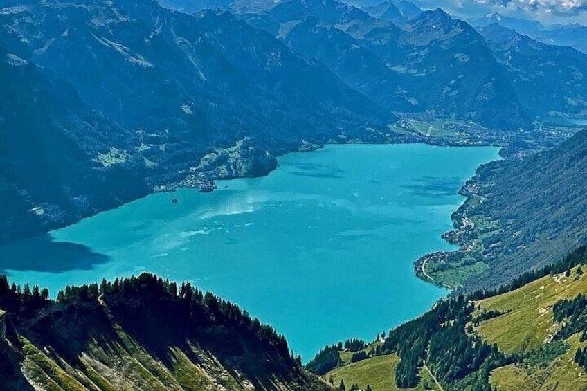 A turquoise lake surrounded by mountains. 3